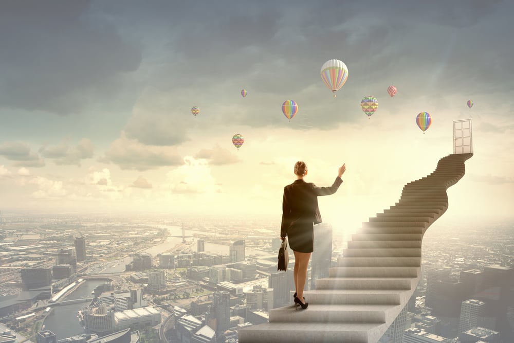 Businesswoman walking up staircase to door in sky-2