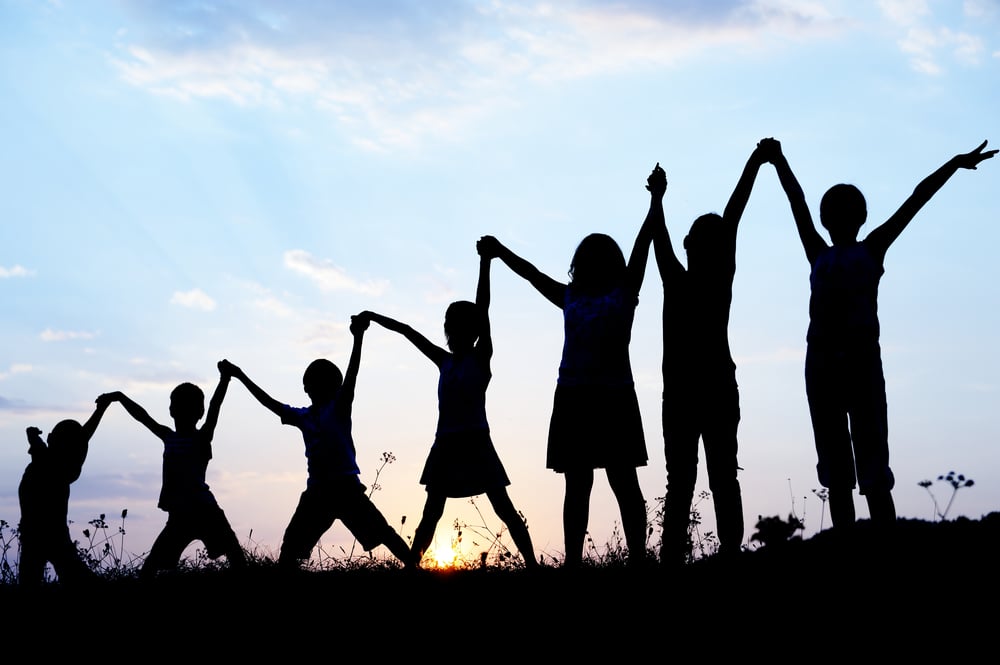 Children silhouettes holding hands up-1