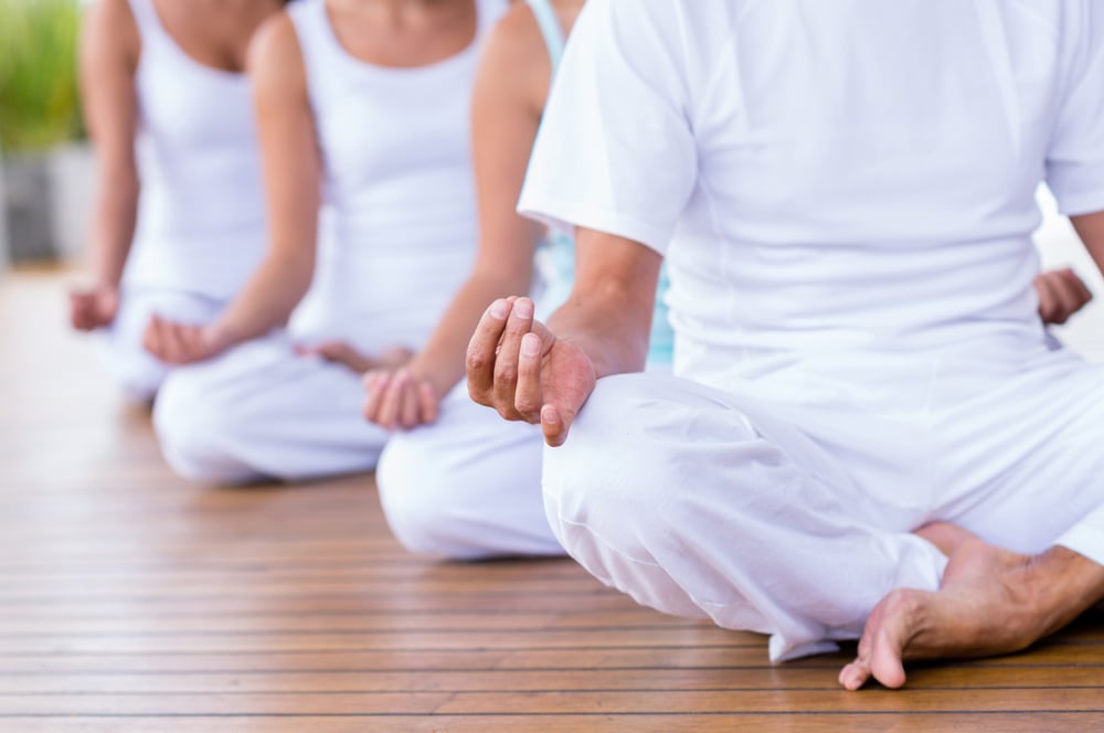 Group of peaceful people meditating  in a yoga studio-1