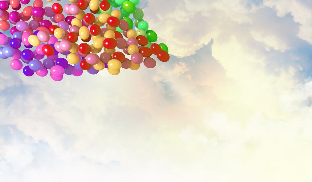 Image of colorful balloons flying in sky
