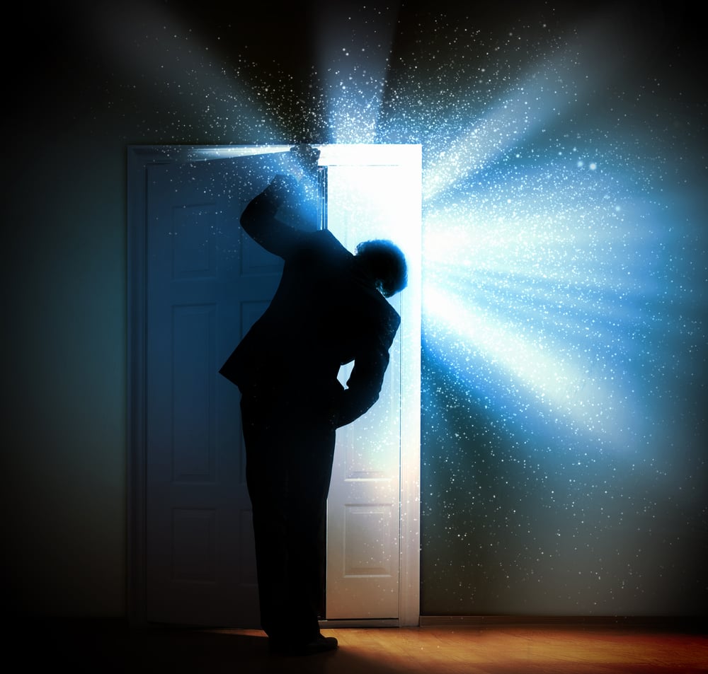Image of young businessman standing with back opening door-1