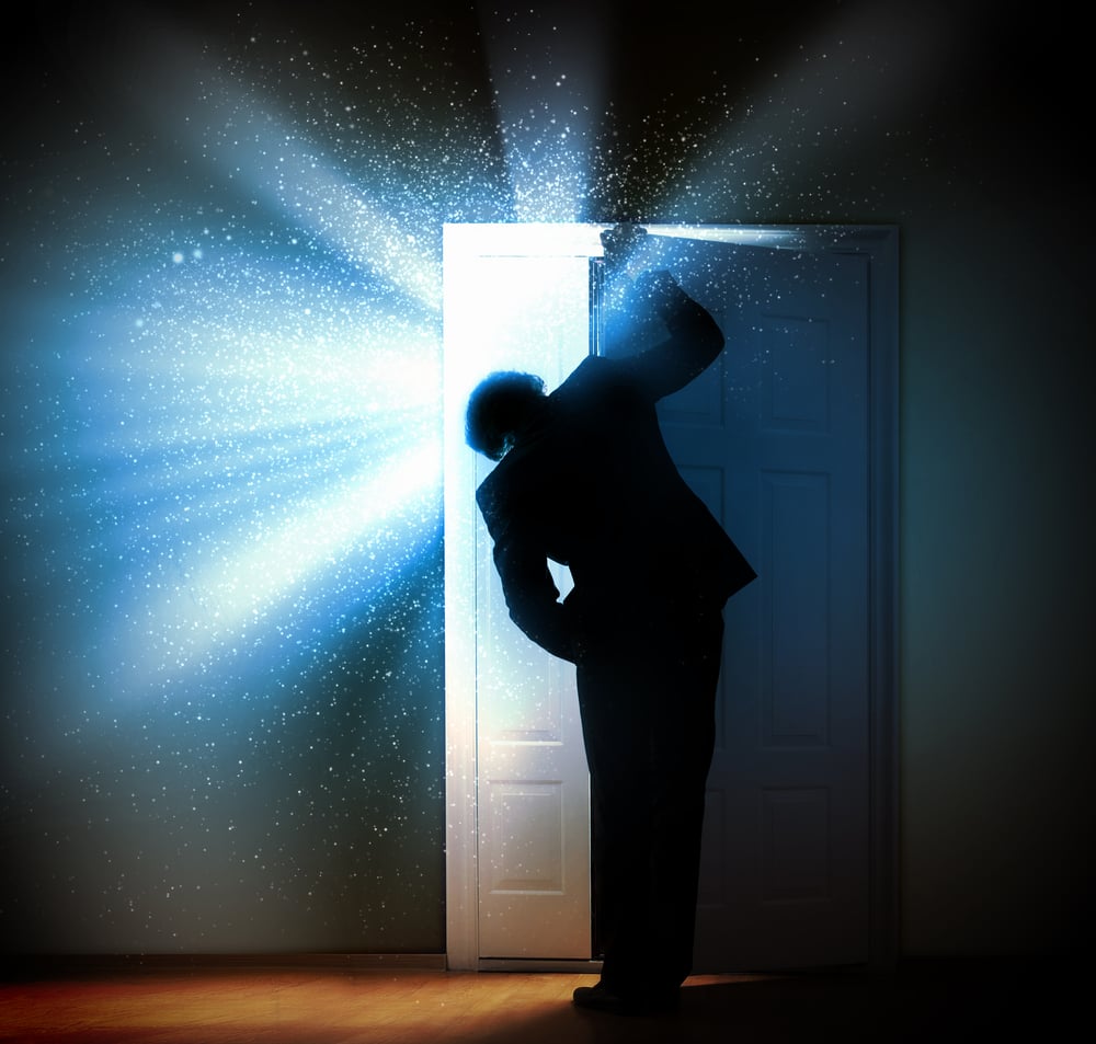 Image of young businessman standing with back opening door