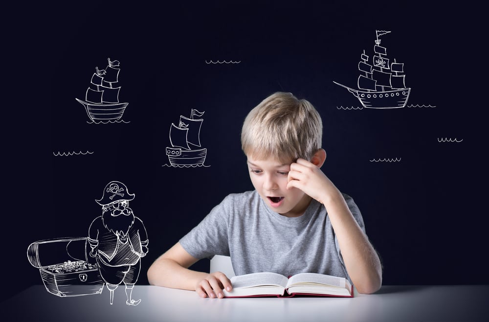 Little boys imagination during reading the adventure book