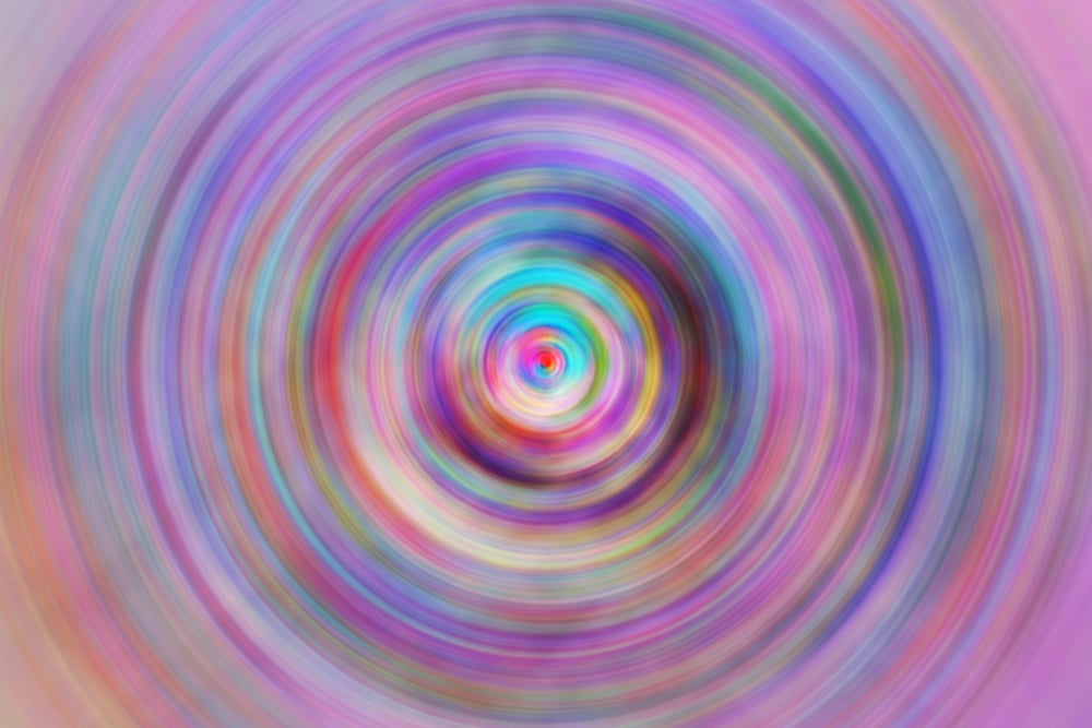 Multicolored abstract vortex gyrating with radial blur, like a moment of a cinematic transition, as in a flashback or movement to another dimension