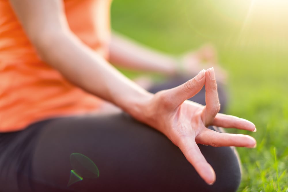 Portrait of a girl taking yoga poses at sunset