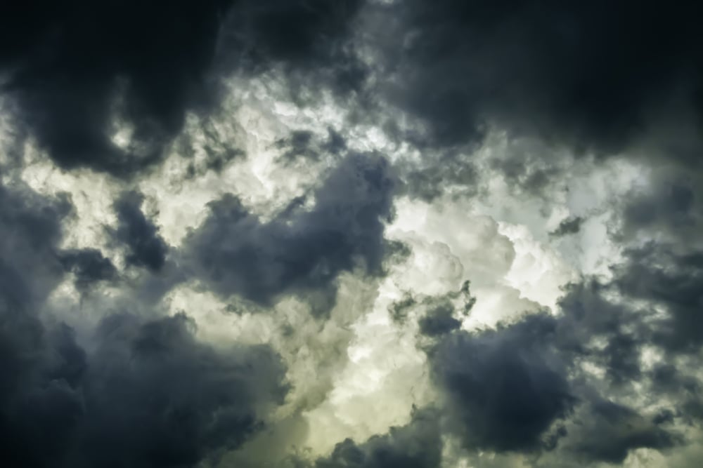 Storm clouds in summer Ragged wind-driven dark clouds move in quickly to obscure large white billows before sunset, for meteorological themes of instability and rapid change-1