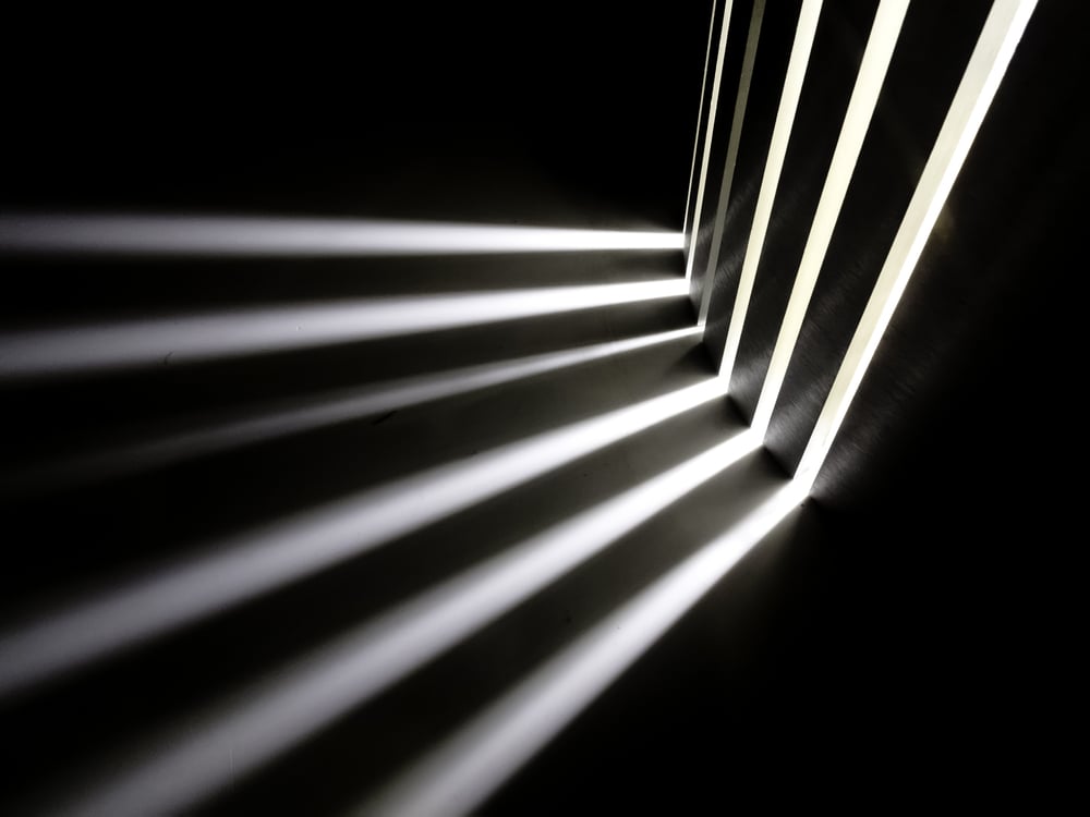 Technology abstract -- white light beams from a hidden source in the dark-1