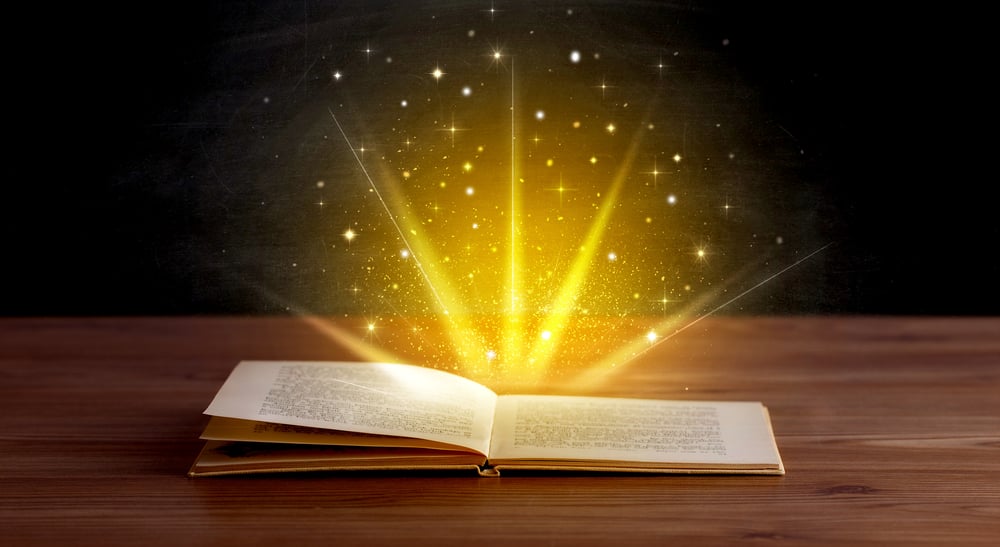 Yellow lights and sparkles coming from an open book