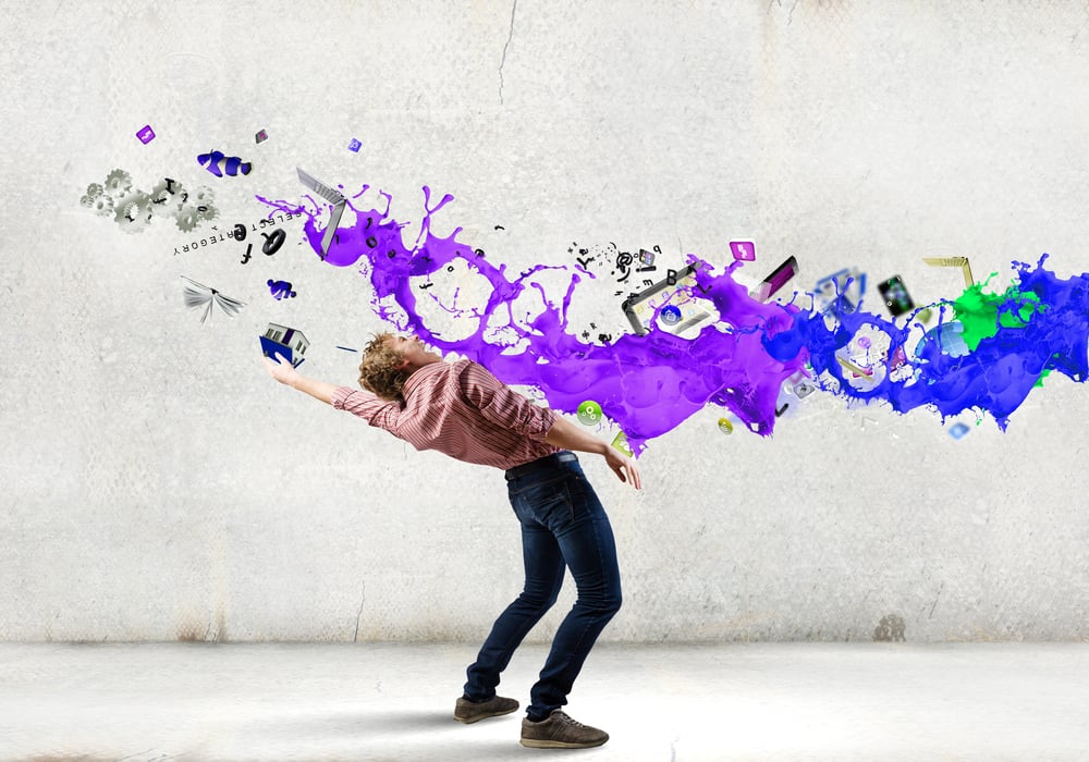 Young guy in casual evading from colorful splashes